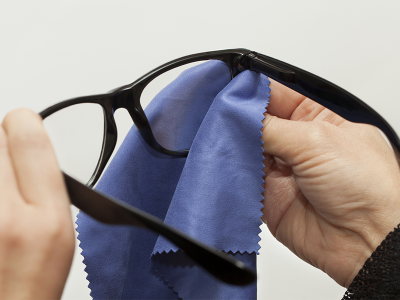 Eyeglasses are a financial investment and it’s important to take proper care of them. Unfortunately, many people don’t take the time to clean glasses properly—opting instead to use the sleeve of a shirt or any nearby cloth. In order to keep your glasses scratch-free, follow our eyeglass cleaning tips! Use a Lens Cloth Always use a dedicated lens or microfiber cloth to clean lenses. Other clothes can have dirt and small particles on them that can cause scratches or other abrasions on lenses. Never Use Household Glass Cleaner You may be tempted to use the cleaner that you use for windows and mirrors on your lenses—but you shouldn’t. These cleaners often contain ammonia that can damage your glasses. Only use eyeglass cleaner or warm water with a bit of dish soap. Clean Often Ensure that you clean your glasses regularly to prevent a buildup of oil and dirt—ideally at least once a day. This buildup can make it difficult to see and can cause symptoms of eyestrain. If your glasses have nose pads, make sure you take some extra time to thoroughly clean them. Store Properly It’s also important to store glasses correctly. When not in use, put glasses in a case to protect them and keep them dust free. It’s also a good idea to keep a soft microfiber cloth in your glasses case for the quick cleanup of smudges while you’re on the go.